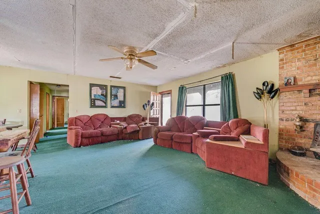 a view of dining table chairs and window