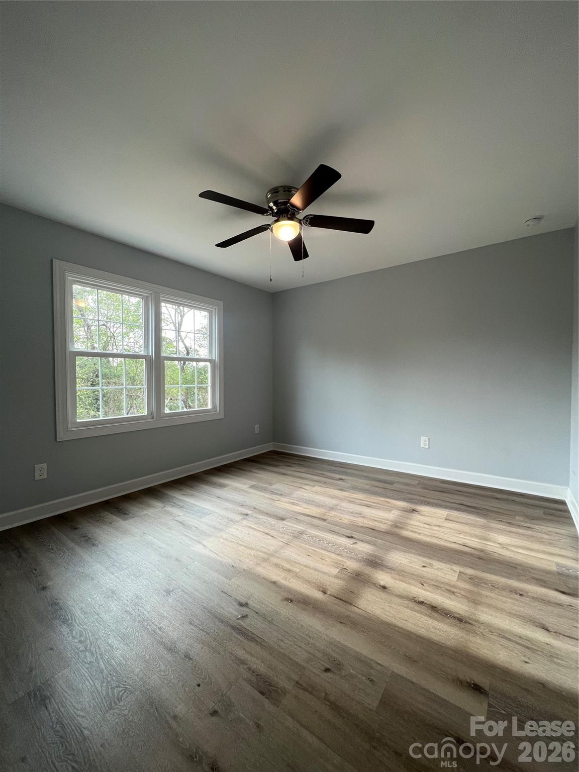 1048 Avondale Road, Unit 13 Lowell, NC 28098 - Photo 9 of 9 wooden floor in an empty room with a window