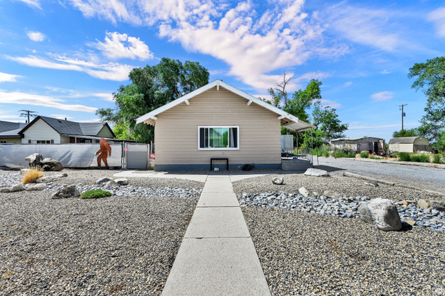 716 East Factory Street Garland, UT 84312 - Photo 1 of 30 Beige siding exterior with white trim and a gabled roofline