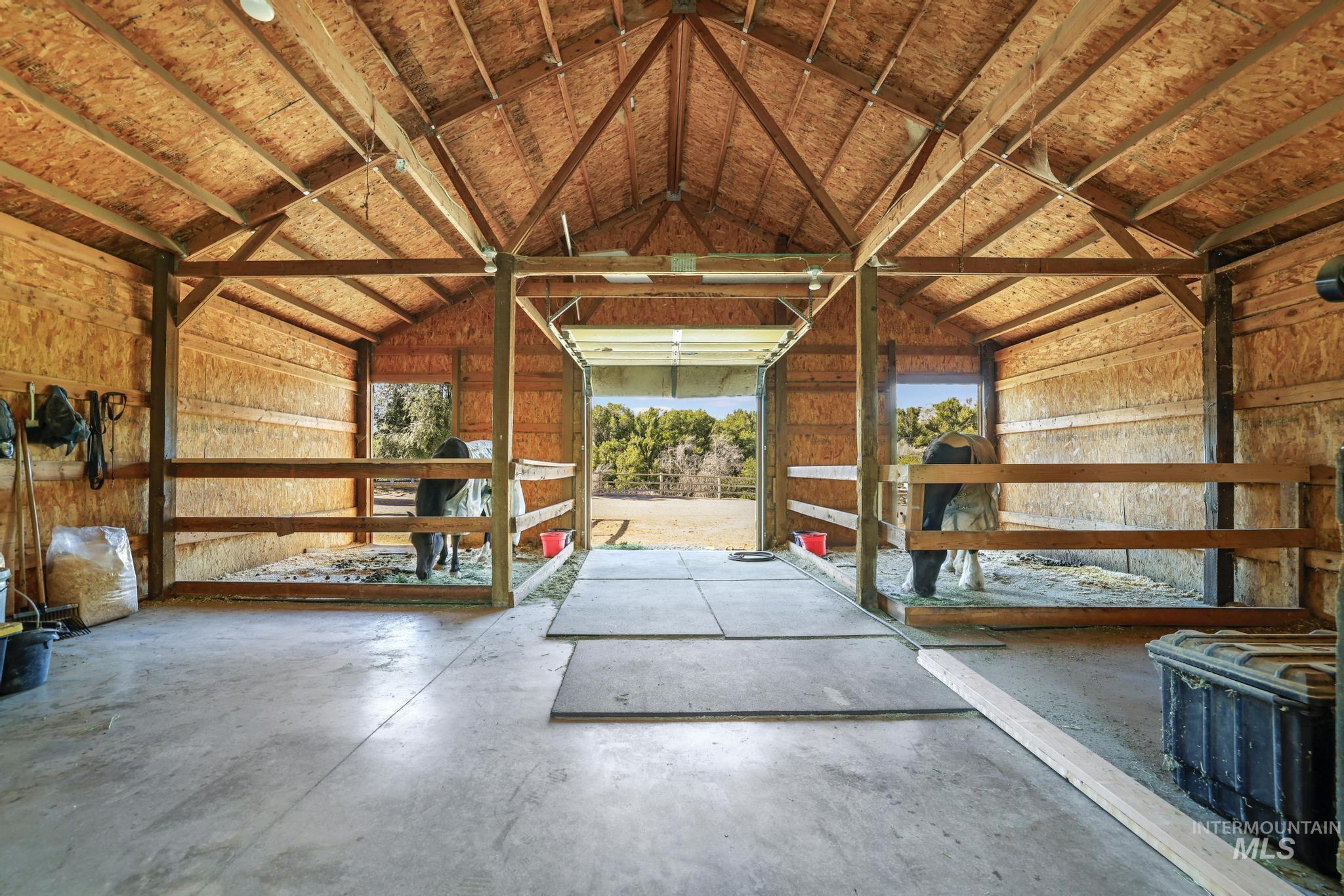 1301 Kanaka Rapids Road Buhl, ID 83316 - Photo 44 of 50 Expansive barn structure with exposed wood beam ceiling and concrete flooring