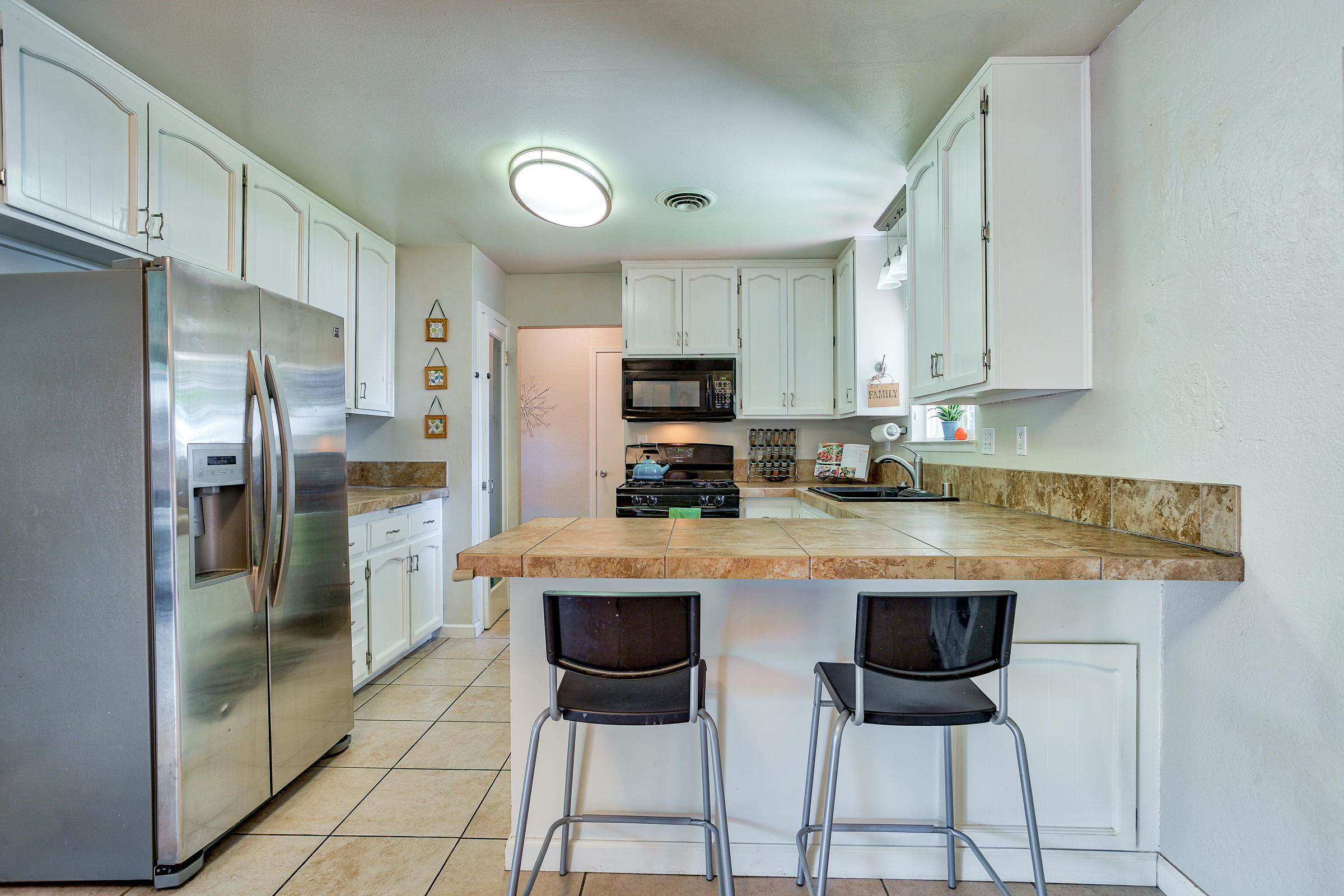 3665 Echo Road Redding, CA 96002 - Photo 6 of 33 a kitchen with stainless steel appliances granite countertop a refrigerator and a stove top oven