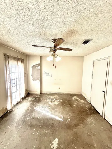 an empty room with windows and entrance