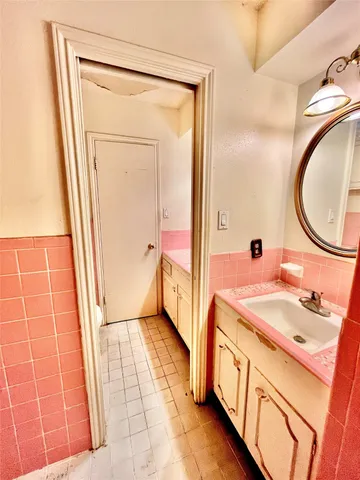 a bathroom with a granite countertop toilet and a sink