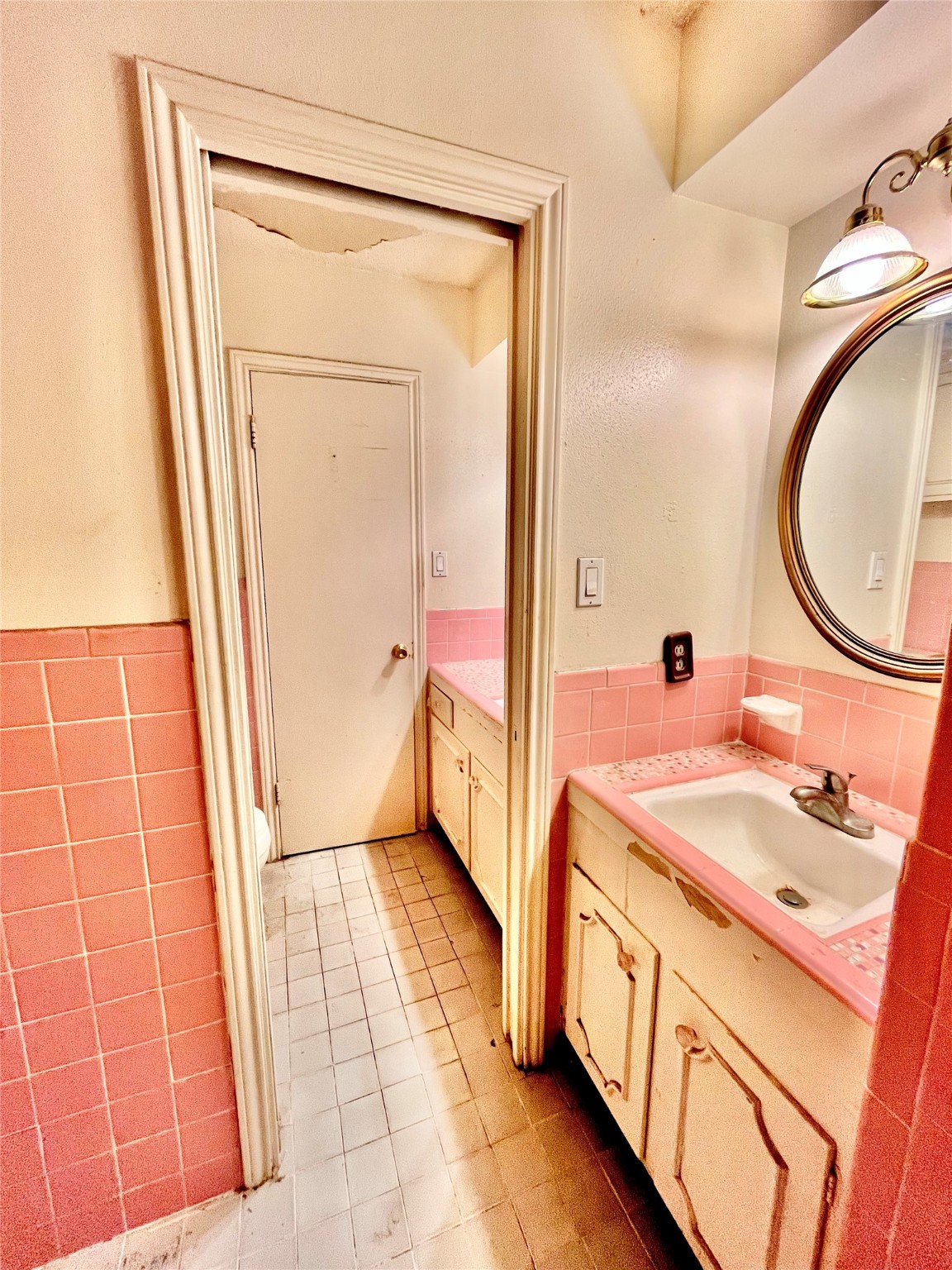 9442 Neuens Road, Unit 9442 Houston, TX 77080 - Photo 14 of 24 a bathroom with a sink a toilet and a mirror