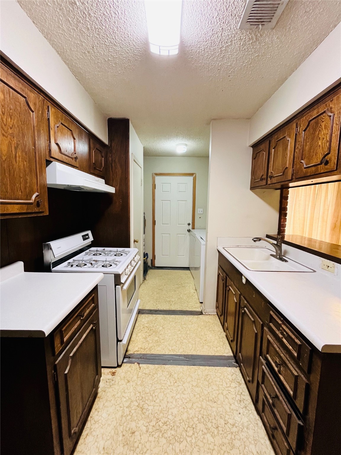 9442 Neuens Road, Unit 9442 Houston, TX 77080 - Photo 6 of 24 a kitchen with a sink stove and cabinets