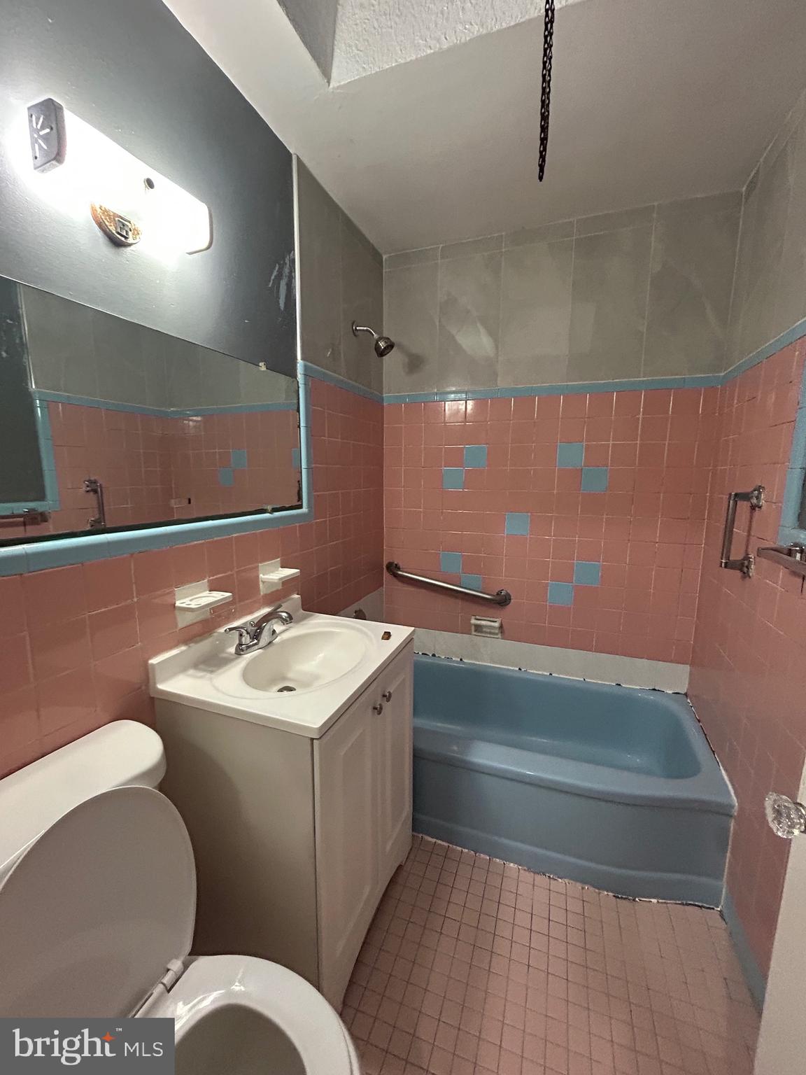 2746 Elbridge Street Philadelphia, PA 19149 - Photo 13 of 21 a bathroom with a sink mirror vanity and toilet