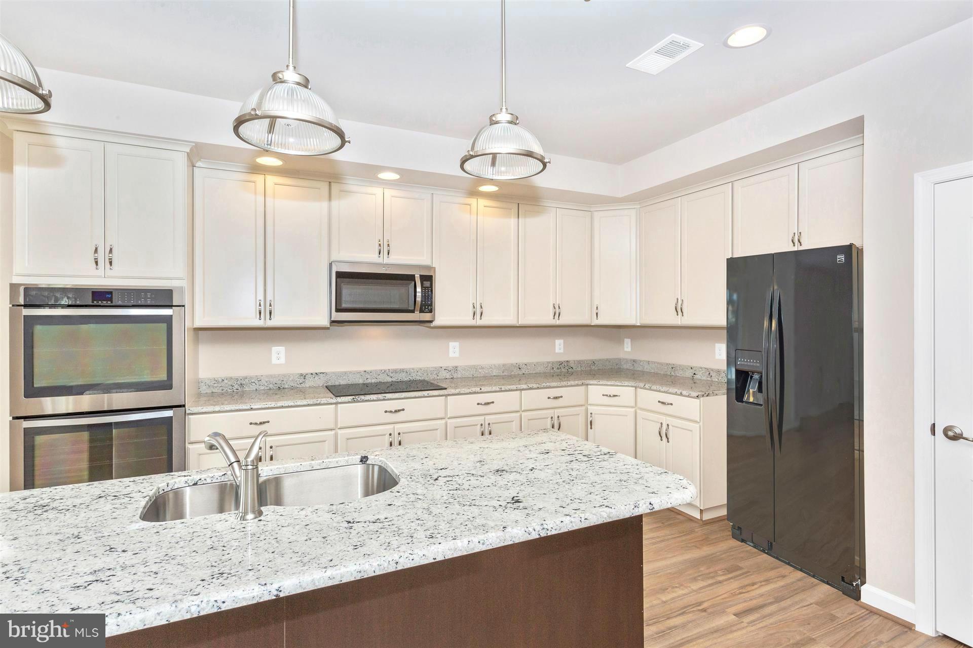 5305 Renn Road Frederick, MD 21703 - Photo 11 of 13 a kitchen with stainless steel appliances granite countertop a sink a stove and refrigerator