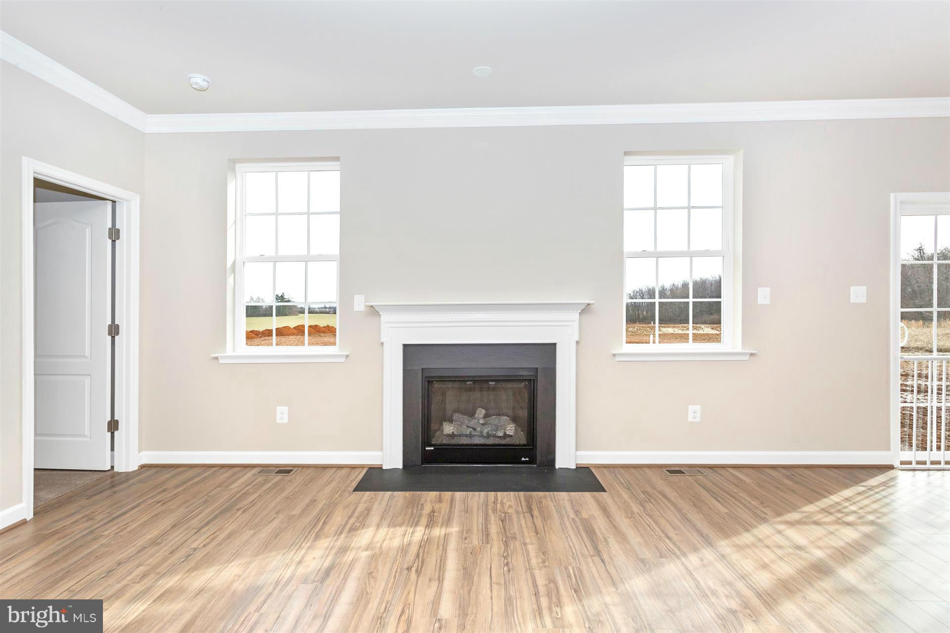5305 Renn Road Frederick, MD 21703 - Photo 12 of 13 an empty room with windows and fireplace