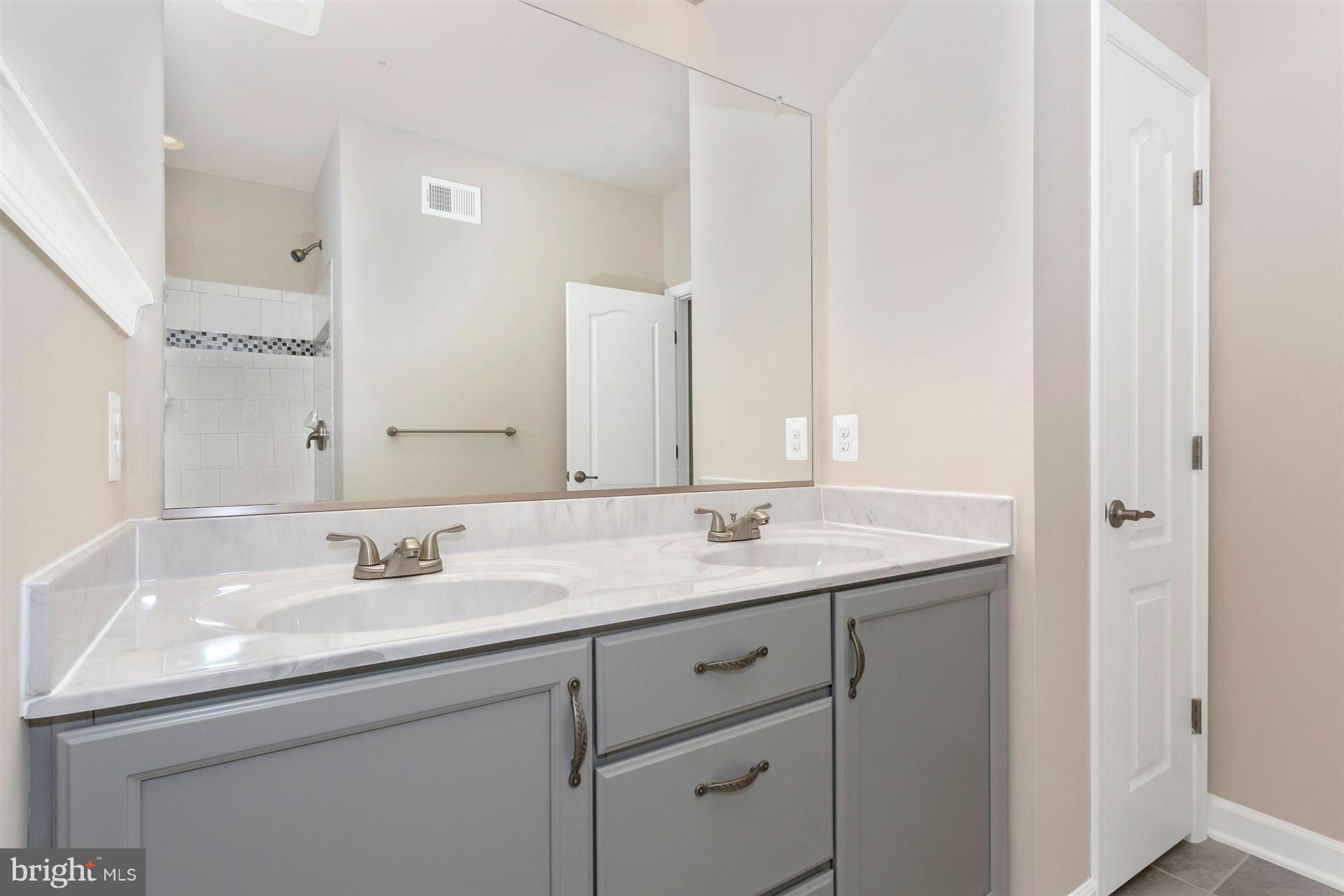 5305 Renn Road Frederick, MD 21703 - Photo 13 of 13 a bathroom with a sink and a mirror