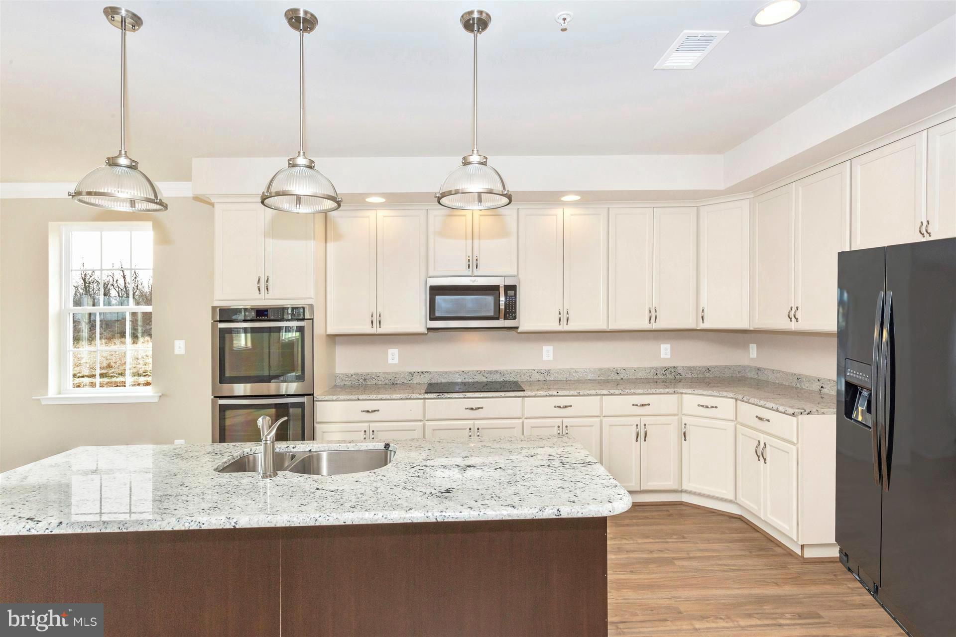 5305 Renn Road Frederick, MD 21703 - Photo 5 of 13 a kitchen with stainless steel appliances granite countertop a sink a refrigerator a stove and a granite counter tops