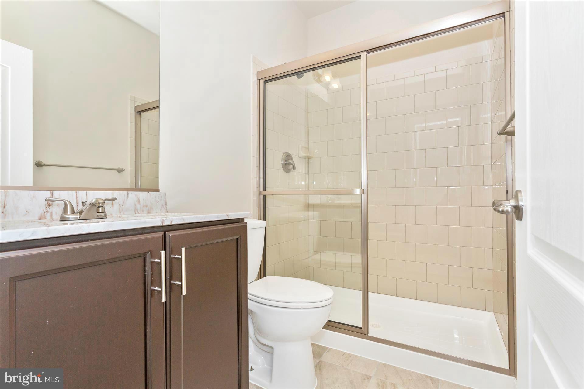 5305 Renn Road Frederick, MD 21703 - Photo 6 of 13 a bathroom with a granite countertop sink toilet and shower