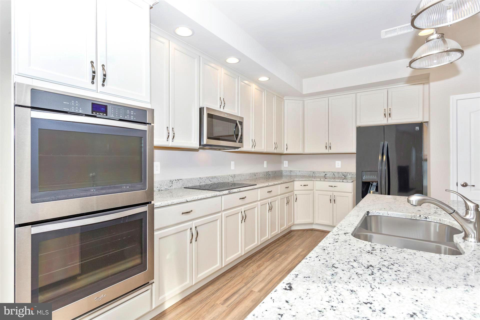 5305 Renn Road Frederick, MD 21703 - Photo 10 of 13 a kitchen with a sink stove and refrigerator