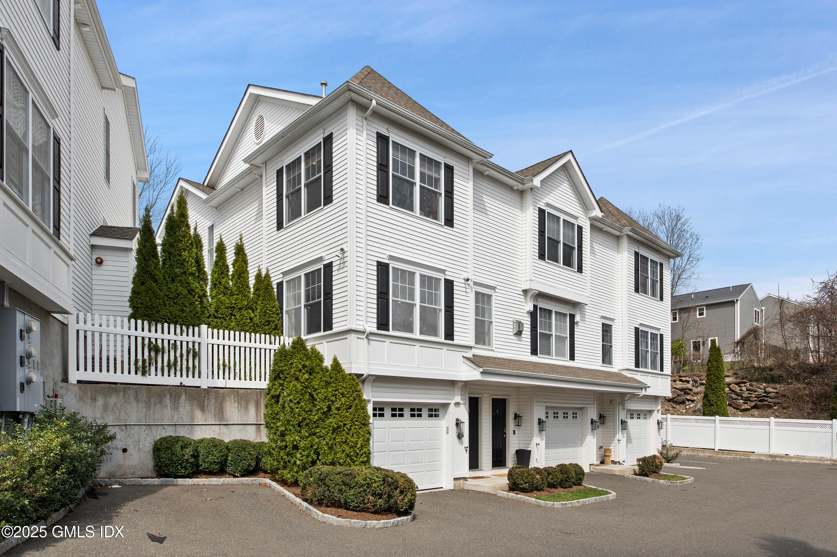 a front view of a residential apartment building with a yard