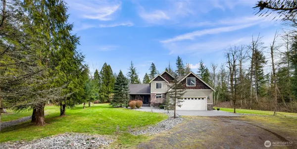 a view of a house with a yard and tree s