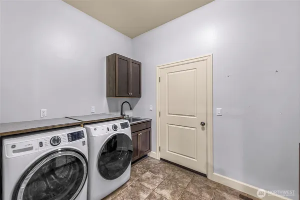 a view of storage and utility room with washer and dryer
