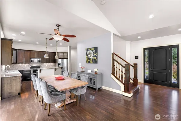 a view of a dining room with furniture wooden floor and a chandelier
