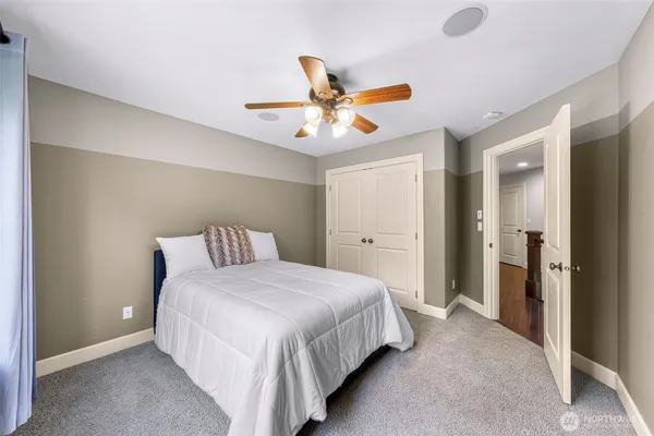 a bedroom with bed and a chandelier