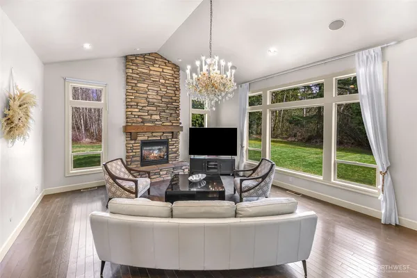 a living room with furniture large window and flat screen tv