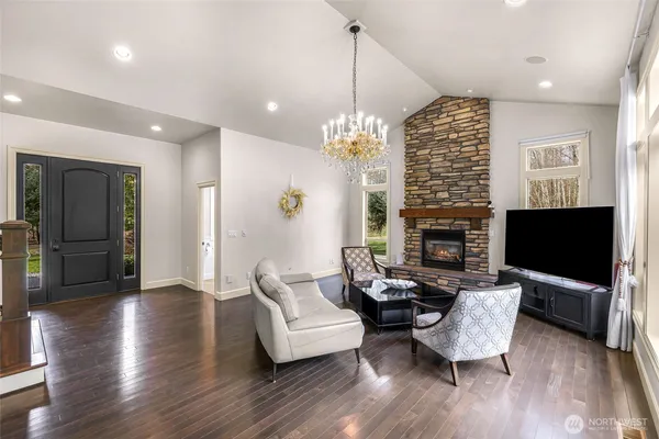 a living room with furniture a fireplace and a flat screen tv