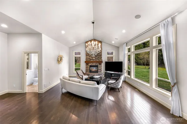 a living room with furniture fireplace and large windows