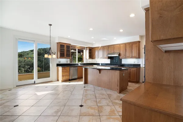 a kitchen with stainless steel appliances granite countertop a refrigerator and a sink
