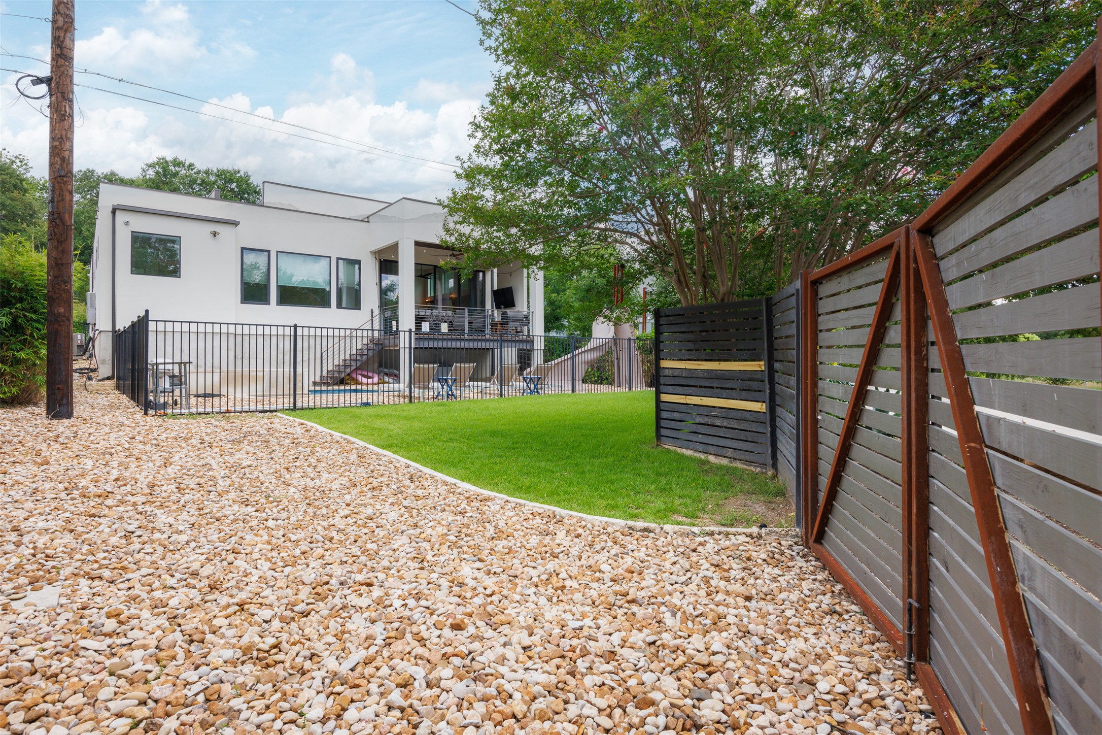 4103 Ridgelea Drive Austin, TX 78731 - Photo 24 of 26 A modern two-story residence boasts a large second-story balcony overlooking a spacious yard.