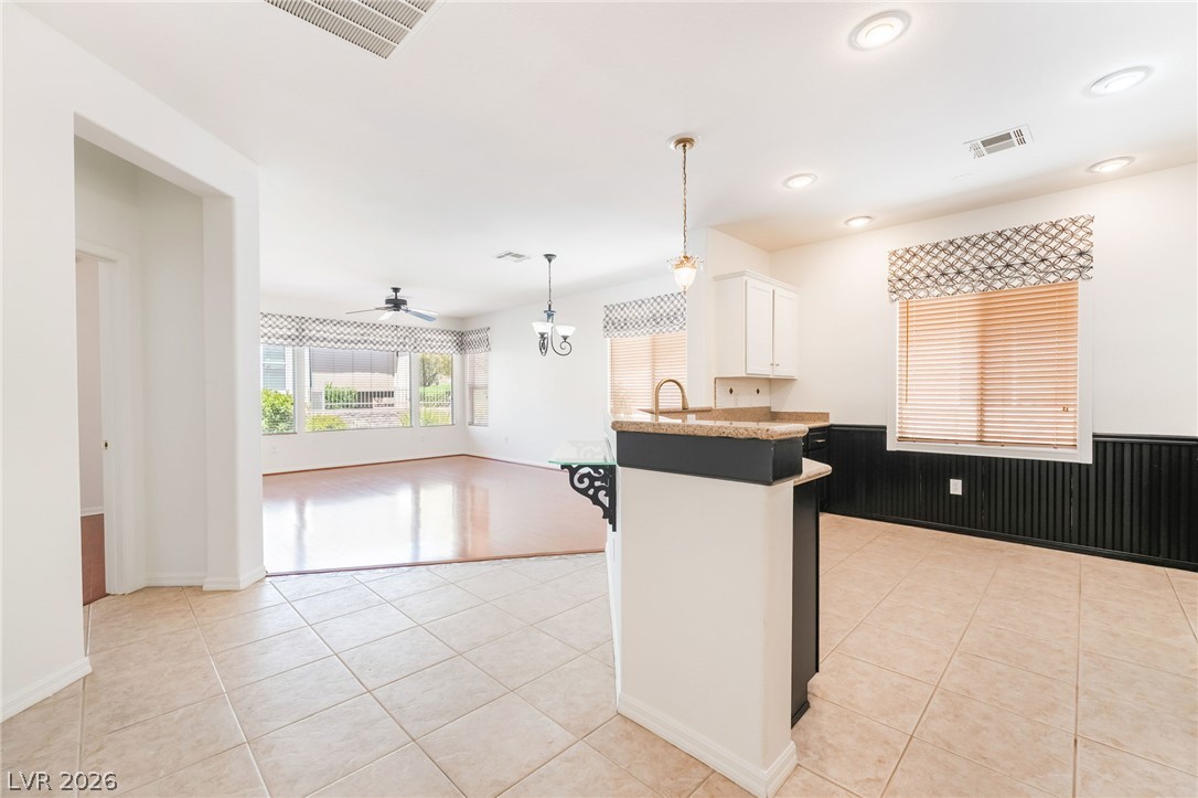 5389 Progresso Street Las Vegas, NV 89135 - Photo 41 of 41 A well-lit interior offers an open floorplan, showcasing a functional kitchen island and polished flooring.