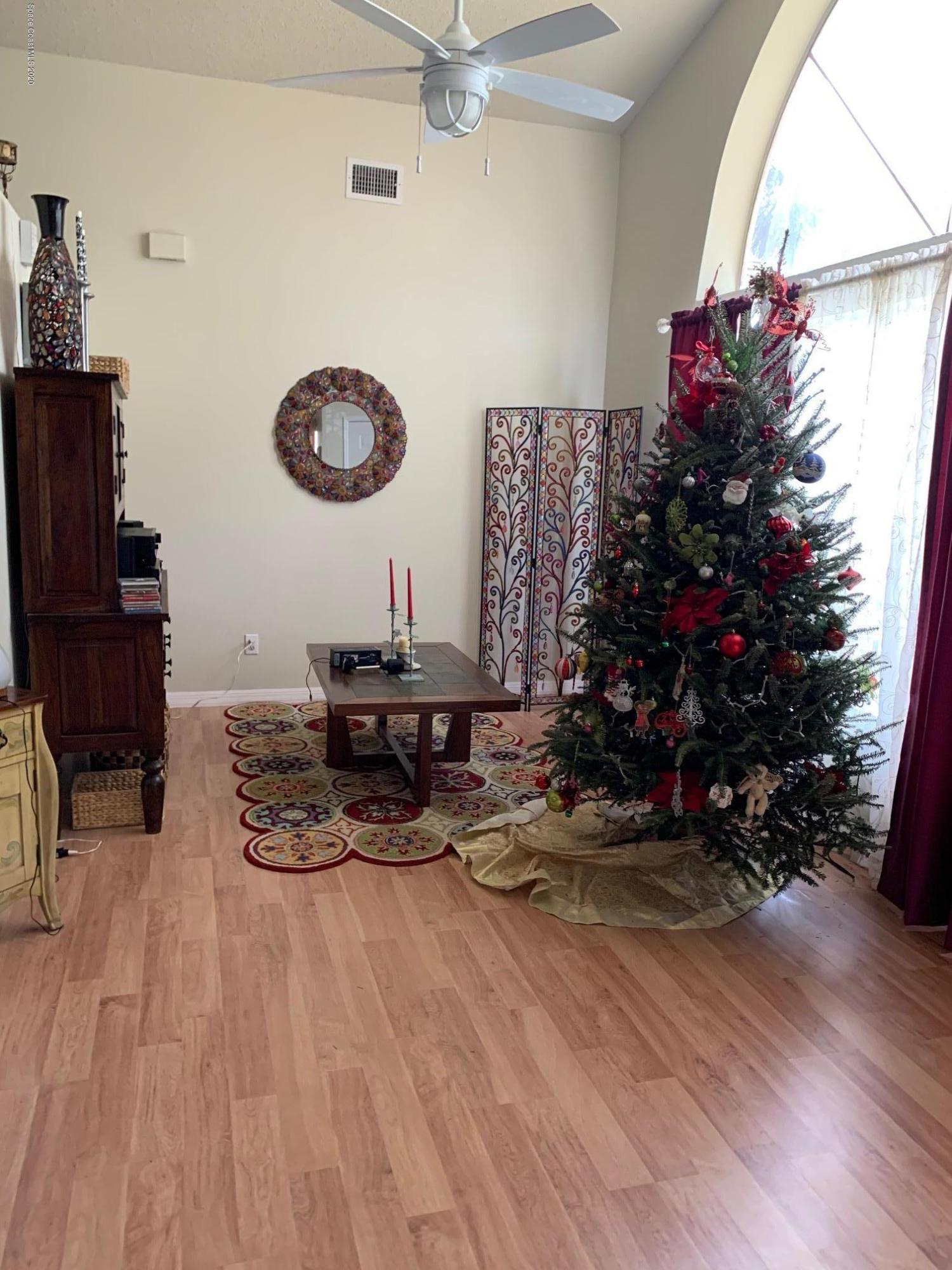 3358 Lakeview Circle Melbourne, FL 32934 - Photo 4 of 14 a view of a workspace with wooden floor