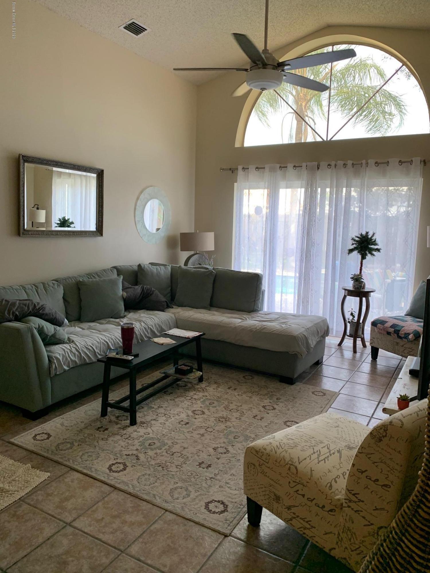 3358 Lakeview Circle Melbourne, FL 32934 - Photo 7 of 14 a living room with furniture and a large window