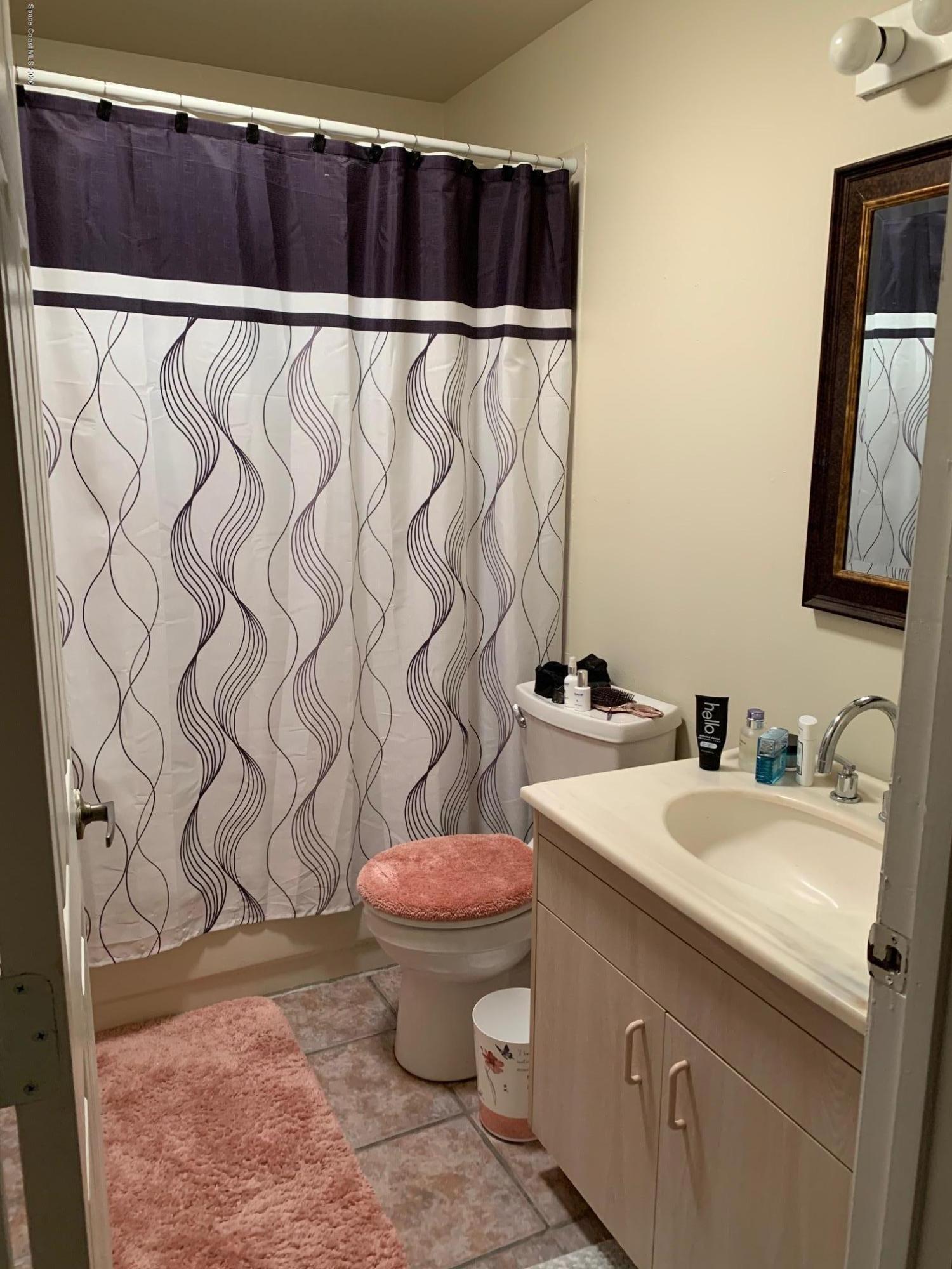 3358 Lakeview Circle Melbourne, FL 32934 - Photo 8 of 14 a bathroom with a sink and a mirror
