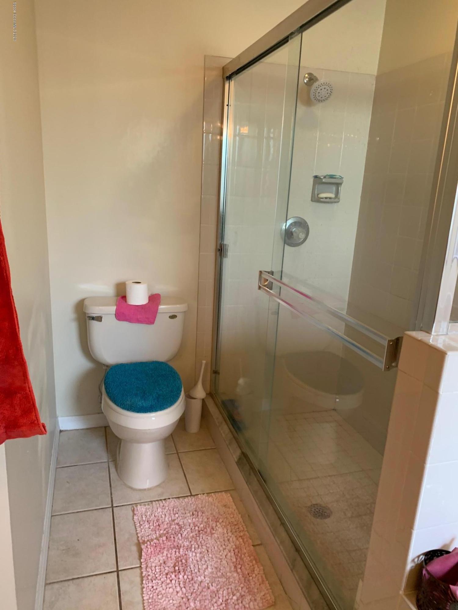 3358 Lakeview Circle Melbourne, FL 32934 - Photo 10 of 14 a bathroom with a toilet and a shower