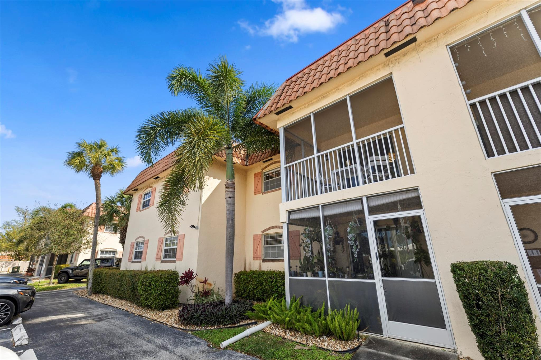101 East McNab Road, Unit 219 Pompano Beach, FL 33060 - Photo 1 of 26 a front view of a building with a garden