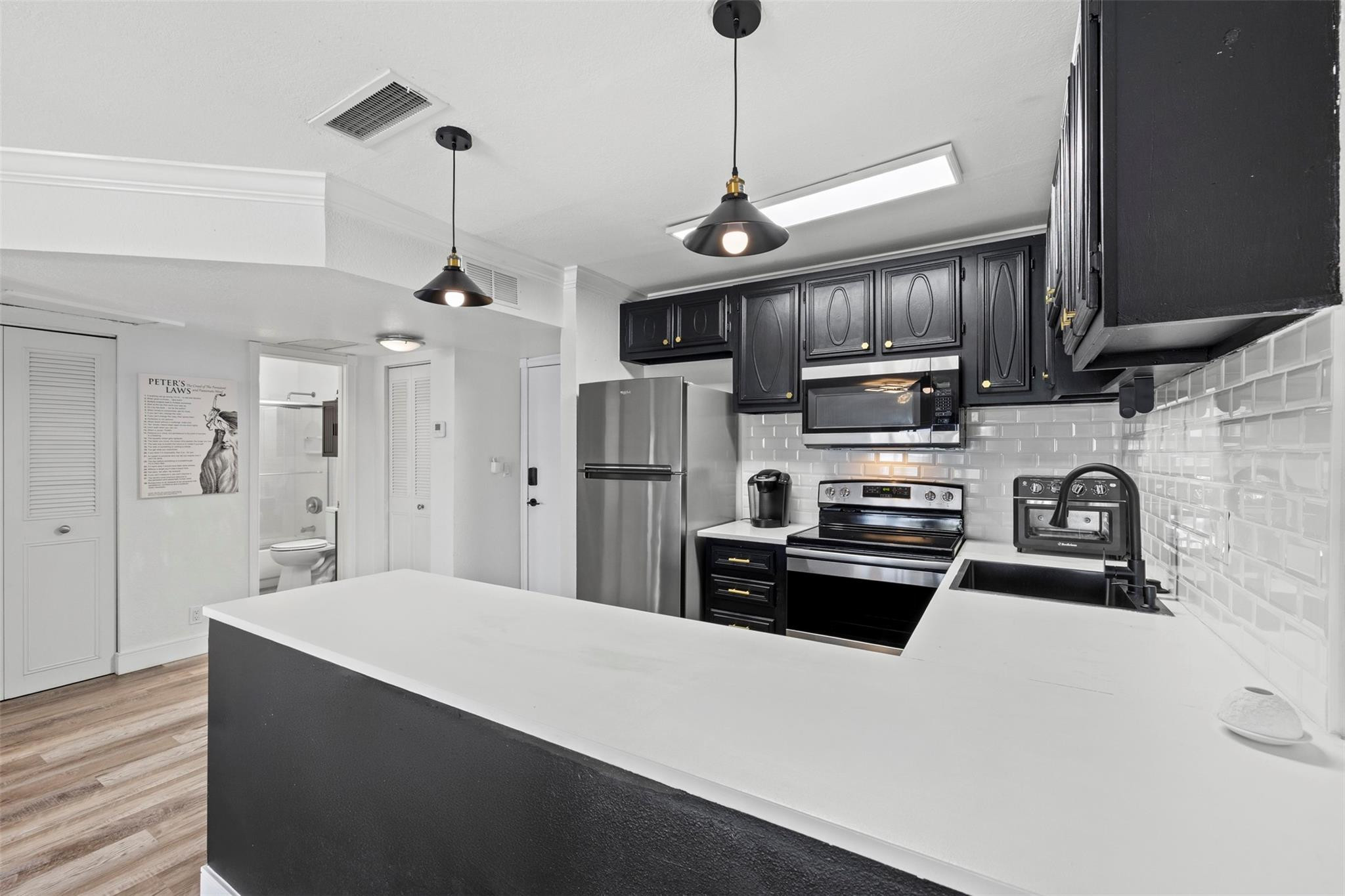 101 East McNab Road, Unit 219 Pompano Beach, FL 33060 - Photo 11 of 26 a kitchen with kitchen island a refrigerator stove and microwave