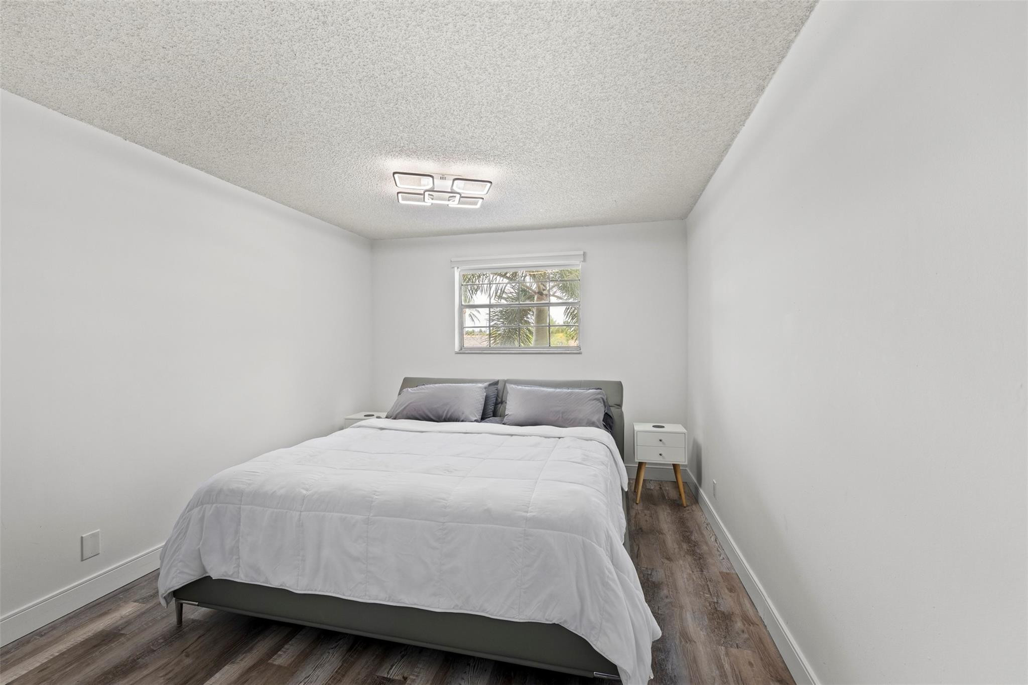 101 East McNab Road, Unit 219 Pompano Beach, FL 33060 - Photo 16 of 26 a bedroom with a bed and a window