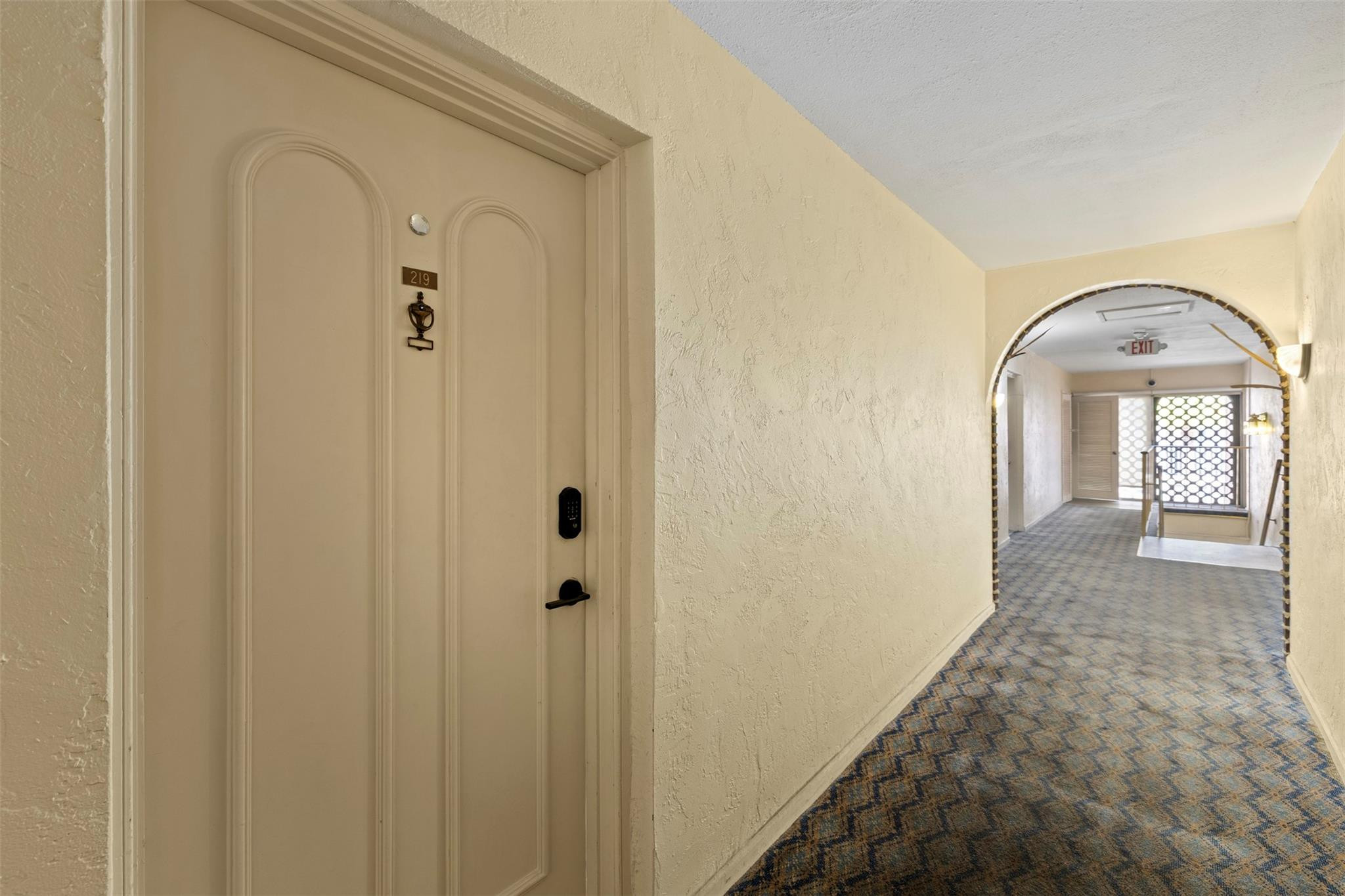 101 East McNab Road, Unit 219 Pompano Beach, FL 33060 - Photo 20 of 26 a view of a hallway with wooden shelves