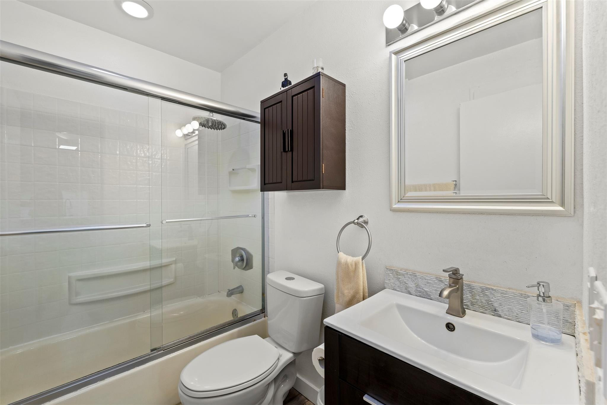 101 East McNab Road, Unit 219 Pompano Beach, FL 33060 - Photo 4 of 26 a bathroom with a sink a toilet and shower