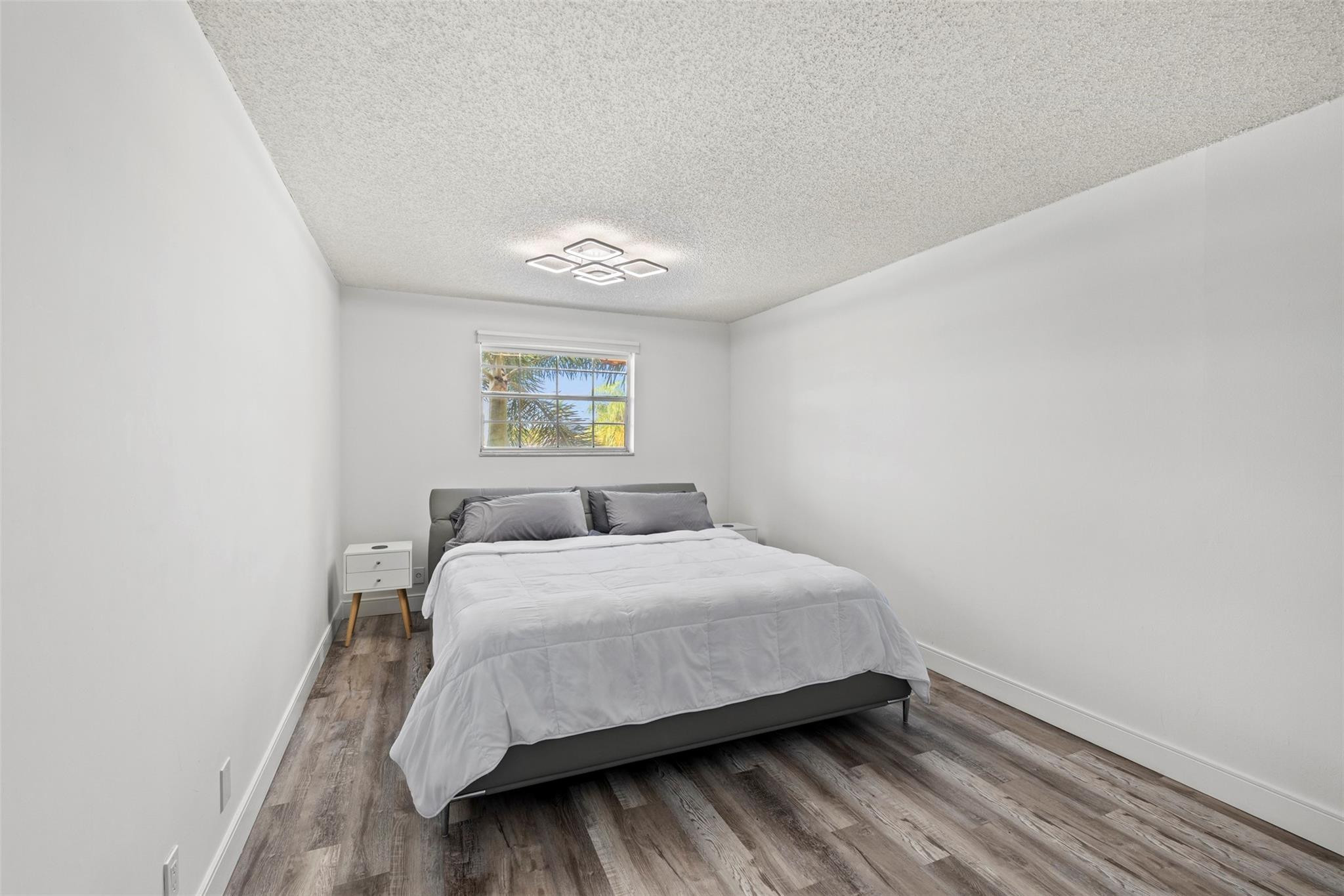 101 East McNab Road, Unit 219 Pompano Beach, FL 33060 - Photo 5 of 26 a bedroom with a bed and a window