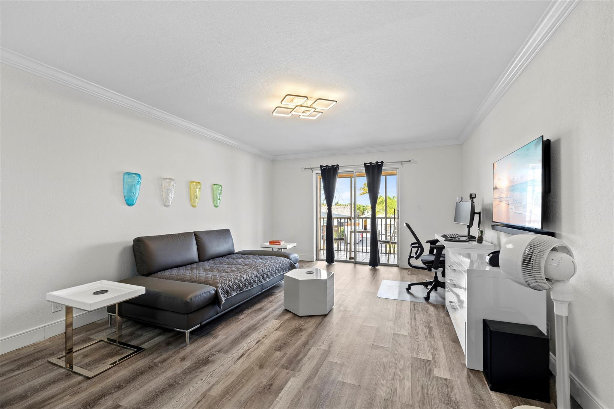 101 East McNab Road, Unit 219 Pompano Beach, FL 33060 - Photo 8 of 26 a living room with furniture and a wooden floor