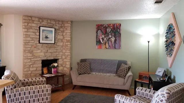 a living room with furniture and a fireplace
