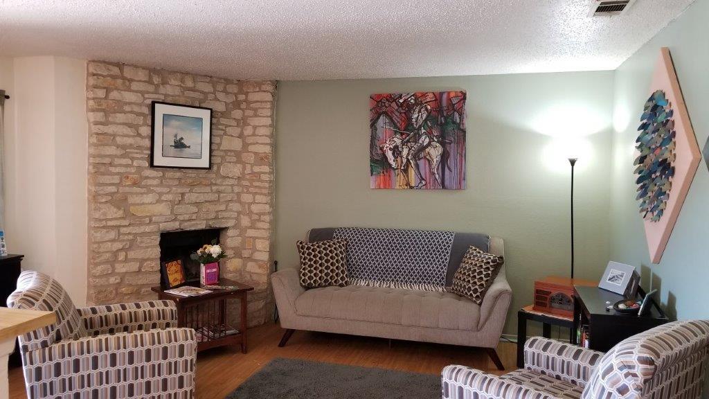 2305 Rachael Court, Unit D Austin, TX 78748 - Photo 4 of 6 a living room with furniture and a fireplace