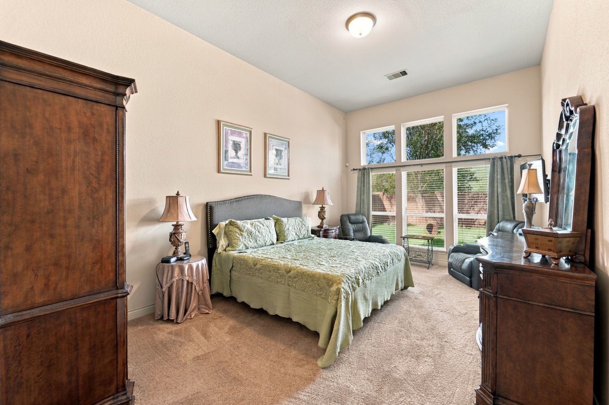 9818 Reston Ranch Court Cypress, TX 77433 - Photo 13 of 38 This view of the primary bedroom highlights the wall of windows, flooding the space with natural light.