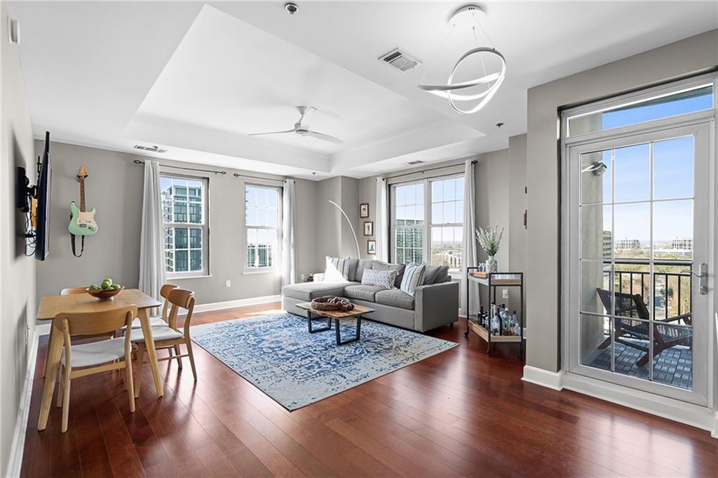 325 East Paces Ferry Road Northeast, Unit 1711 Atlanta, GA 30305 - Photo 1 of 29 a living room with furniture and wooden floor