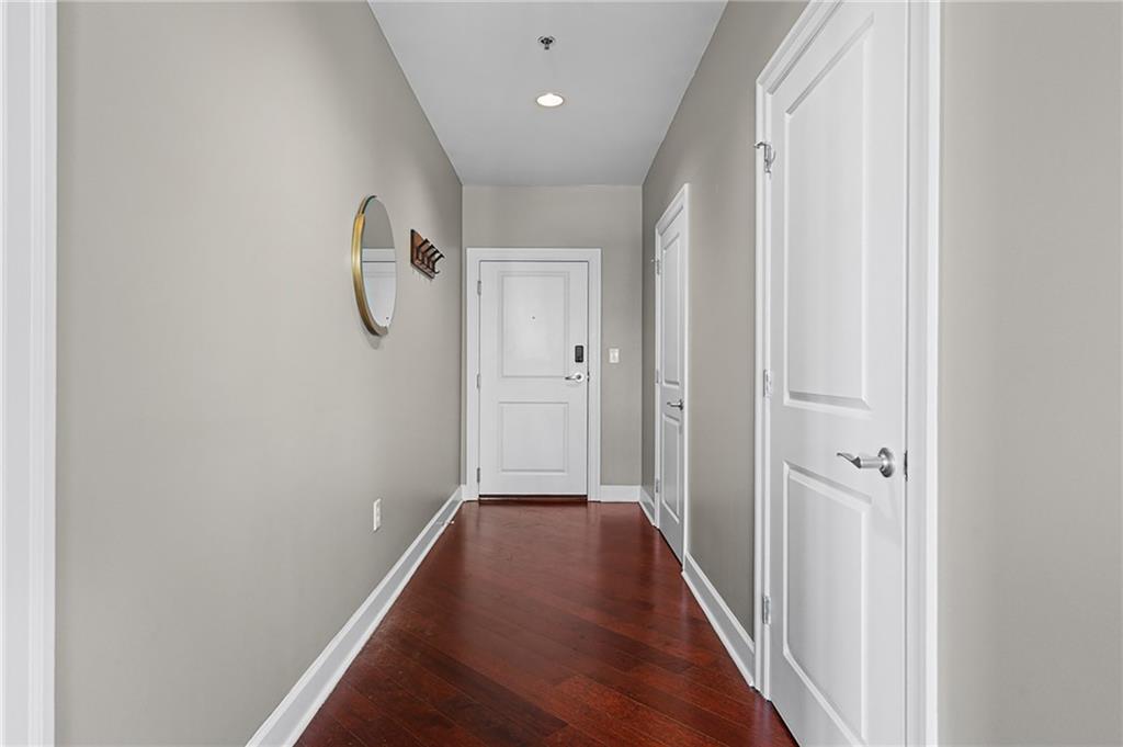 325 East Paces Ferry Road Northeast, Unit 1711 Atlanta, GA 30305 - Photo 17 of 29 a view of a hallway with wooden floor
