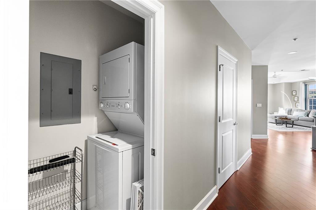 325 East Paces Ferry Road Northeast, Unit 1711 Atlanta, GA 30305 - Photo 18 of 29 a view of a hallway with couch and wooden floor