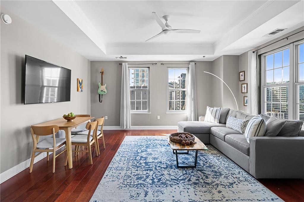 325 East Paces Ferry Road Northeast, Unit 1711 Atlanta, GA 30305 - Photo 3 of 29 a living room with furniture and a large window
