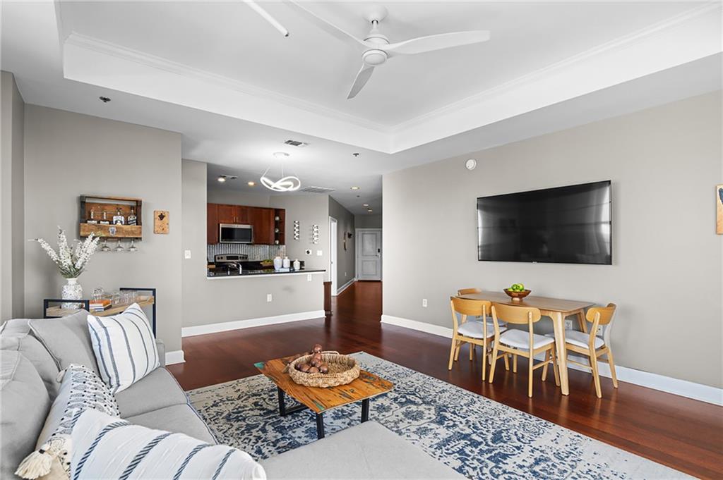 325 East Paces Ferry Road Northeast, Unit 1711 Atlanta, GA 30305 - Photo 5 of 29 a living room with furniture and a flat screen tv
