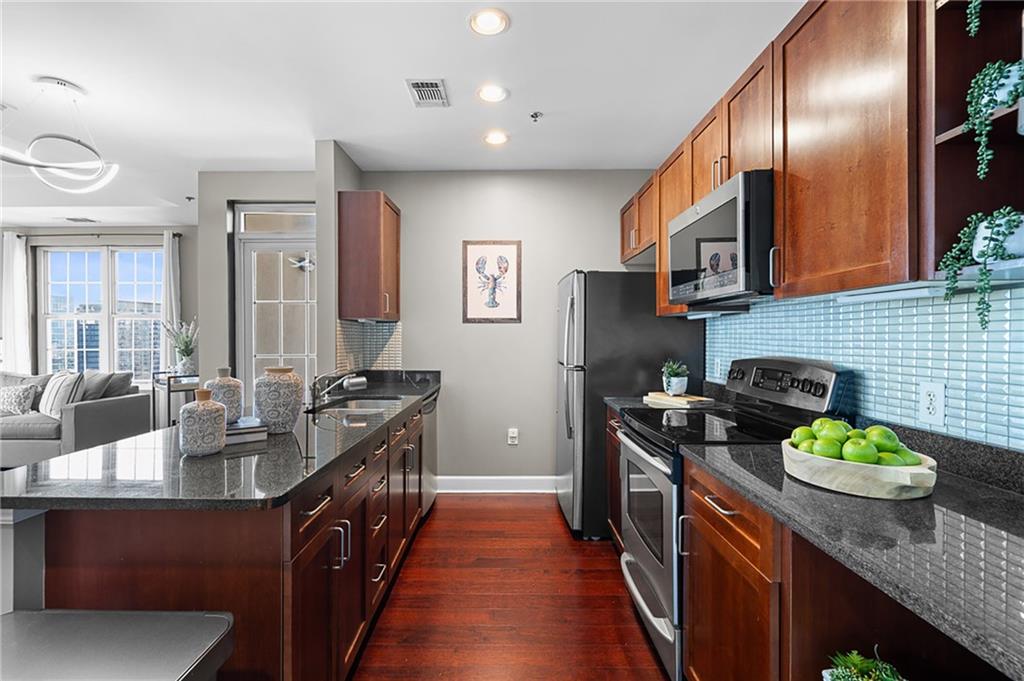 325 East Paces Ferry Road Northeast, Unit 1711 Atlanta, GA 30305 - Photo 8 of 29 a kitchen with granite countertop lots of counter top space