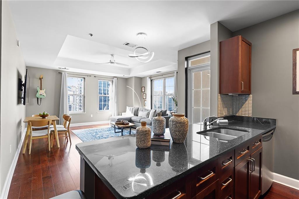 325 East Paces Ferry Road Northeast, Unit 1711 Atlanta, GA 30305 - Photo 9 of 29 a kitchen with a table chairs and wooden floor