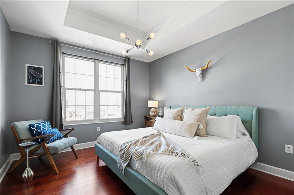 325 East Paces Ferry Road Northeast, Unit 1711 Atlanta, GA 30305 - Photo 10 of 29 a bedroom with bed and window with chair