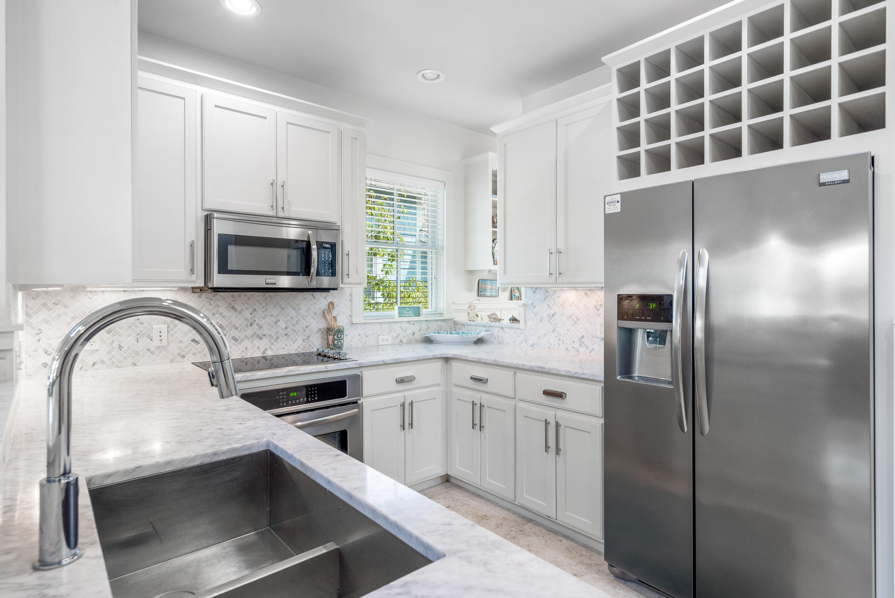 247 Salt Lane Watersound, FL 32461 - Photo 16 of 45 a kitchen with appliances a sink and cabinets